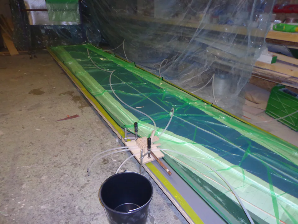 Composite reinforcement laid into a long yacht component mould