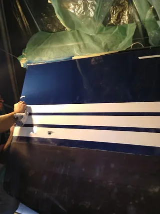Repaired bow with blue finish and stripes reinstated
