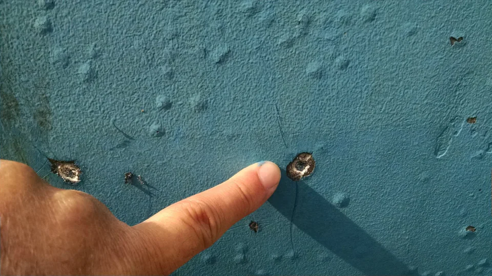 Close view of marks and coating damage on a hull surface