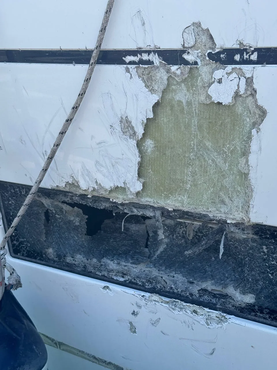 Close view of damaged yacht hull laminate and coating
