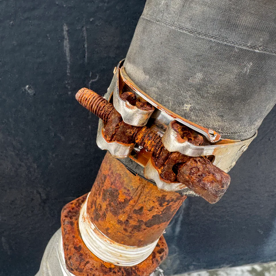 Hose connection and corroded clamps on a yacht fitting
